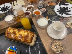 a table topped with a table with food and drinks at Chambre des Tours 2 in Mont-Saint-Éloi