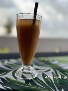 a drink in a glass sitting on a table at Newdarling beach hotel in Watamu