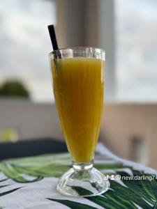 a glass of orange juice sitting on a table at Newdarling beach hotel in Watamu