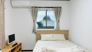 a bedroom with a bed and a window at Bon House Tokyo Private Luxury Retreat with Free Parking Reservation Required in Tokyo