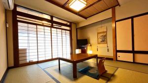 a living room with a table and a window at Taiyokan in Minakami