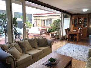 a living room with a couch and a table at Hills Manor House in Greenmount