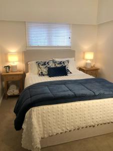 a bedroom with a large white bed with two lamps at Hills Manor House in Greenmount