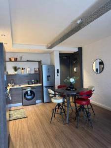 a kitchen with a table and chairs in a room at Enzo Stay -The Matrix 505 , Century City in Cape Town