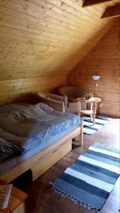 a bedroom with a bed and a table in a attic at Zruby Liptovský Ján in Liptovský Ján