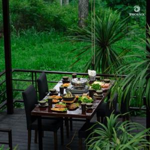 a table with plates of food on a patio at Phoenix Mộc Châu Resort in Mộc Châu