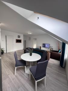 a living room with a table and a couch at Home Dulcesa in Sibiu