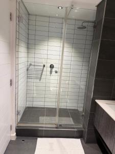 a shower with a glass door in a bathroom at Enzo Stay -The Matrix 505 , Century City in Cape Town +12 photos