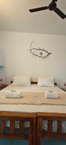 a large bed with two pillows on top of it at Yog Inn in Varkala