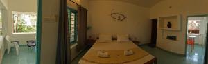 a bedroom with a bed in a room at Yog Inn in Varkala +33 photos