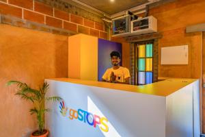 a man standing behind a counter in a room at goSTOPS Pondicherry Near Auroville in Auroville