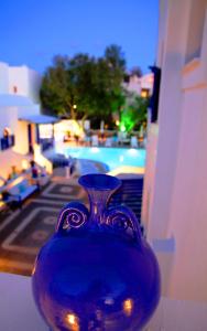 a blue vase sitting on top of a table at Samson΄s Village in Perissa