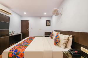 a bedroom with a large bed in a room at FabHotel Upstream Mysore Road in Bangalore