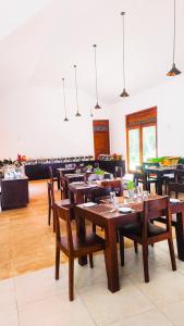 a large dining room with wooden tables and chairs at Castello Hotel in Polonnaruwa