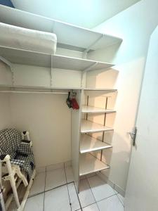 a room with white shelves and a bed in it at La Perle de la Baie - Plages à pied & Hyper centre in Pornichet +10 photos