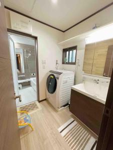 a bathroom with a sink and a washing machine at Bon House Tokyo Private Luxury Retreat with Free Parking Reservation Required in Tokyo