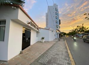 a building on the side of a city street with a street at Hotel Tariq Monteria in Montería