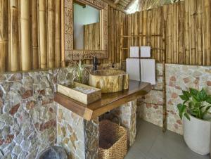 a bathroom with a sink and a mirror at ARYA Sumba - Kodi Resort in Tambolaka