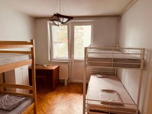 a room with three bunk beds and a window at Center House Hostel in Prishtinë