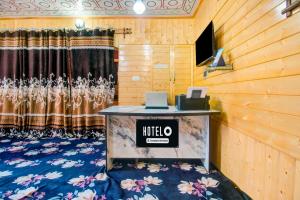 a hotel room with a table with a laptop on it at Townhouse Brein Nishat in Srinagar