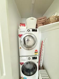 a laundry room with a washer and dryer at Hickey Vale Farm Studio in Broadford