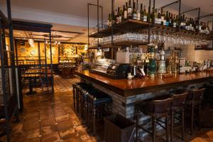a bar with stools and bottles of alcohol at Hotel Gimmond Kyoto in Kyoto