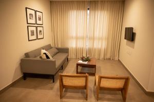 a living room with a couch and a table at Ara Ki Serviced Apartments in Kohīma