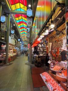 a store with colorful ceilings and a market with food at Hotel Gimmond Kyoto in Kyoto