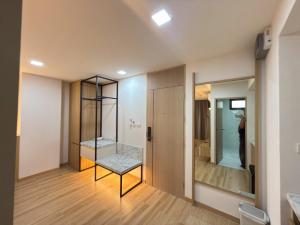 a bathroom with a bench in the middle of a room at Armass Residence in Bangna