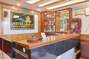 a bar in a hotel with a sign on the wall at OYO 839 Hotel Middle Temple in Kathmandu