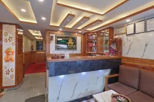 a bar in a restaurant with a couch and a counter at OYO 839 Hotel Middle Temple in Kathmandu