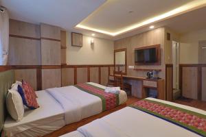 a hotel room with two beds and a television at OYO 839 Hotel Middle Temple in Kathmandu