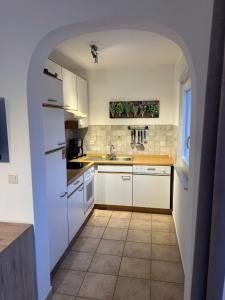 a kitchen with a white refrigerator and a tile floor at Villa Nikki in Bilice
