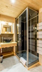 a glass shower in a bathroom with a wooden ceiling at Chalet l'Aiglon in Saint-Gervais-les-Bains +41 photos