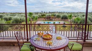 a table with plates of food on a balcony at Maison safou in Marrakesh