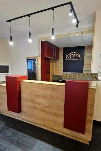 a restaurant with a counter with a sign that reads nocacia at NOVA Motel in Międzyrzecz