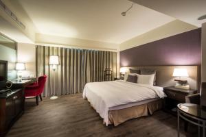 Ένα ή περισσότερα κρεβάτια σε δωμάτιο στο Delight Hotel