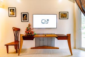 a wooden desk with a christmas tree on a wall at Casa Negrense Private Resort in Dauin