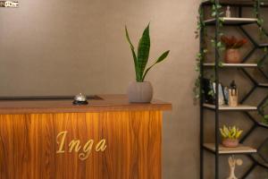 a potted plant sitting on top of a wooden podium at Inga Hotel Yerevan in Yerevan