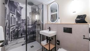 a bathroom with a sink and a shower at Campanile NATURE - Lyon Est Bron Eurexpo in Bron