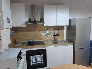 a kitchen with a sink and a refrigerator at A Casa di MaPe in Viterbo