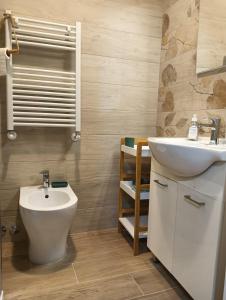 a bathroom with a sink and a toilet at A Casa di MaPe in Viterbo +18 photos