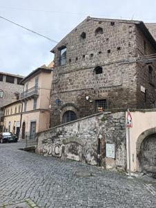 an old stone building on a cobblestone street at A Casa di MaPe in Viterbo