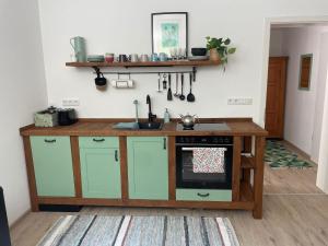 a kitchen with a counter and a stove top oven at Ferienwohnung am Kienbach in Herrsching am Ammersee