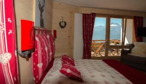 a bedroom with a bed with a view of a balcony at Le Bristol - Villars Bristol Apartments in Villars-sur-Ollon