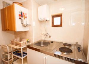 a small kitchen with a sink and a counter at Studio Marin in Baška