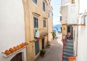 an alley in an old town with buildings at Studio Marin in Baška