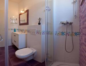 a bathroom with a shower and a toilet and a sink at Apartments Paradise With Amazing Sea View in Vinišće