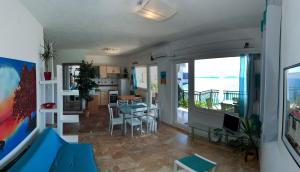 a kitchen and living room with a view of the ocean at Apartments Paradise With Amazing Sea View in Vinišće +52 photos