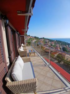 a balcony with chairs and a view of the ocean at RED House Rabac in Rabac